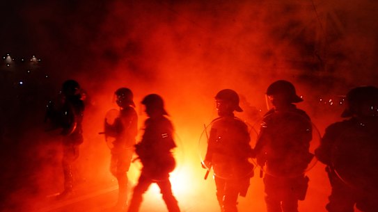 Police out in force as fans set off flares in Swan Street, Richmond, ahead of the A-League grand final.