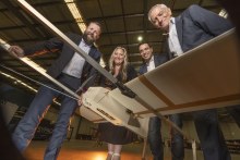 Sypac’s chief engineer Ross Osborne, and its CEO Amanda Holt, join managing director David Vicino and founder and chairman George Vicino with one of the drones that have been deployed in the Ukraine conflict.