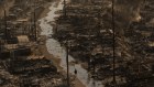 A person walks amid the destruction left behind by the Palisades Fire.