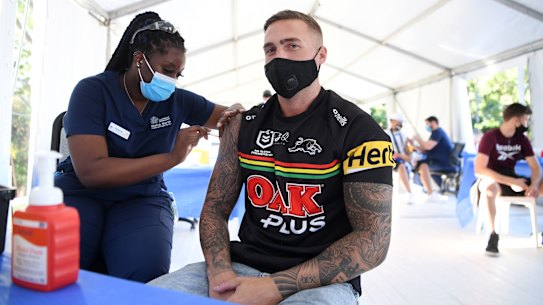 Panthers fan Shane Binns receives the COVID-19 vaccination at a pop-up clinic at Suncorp Stadium on Sunday.