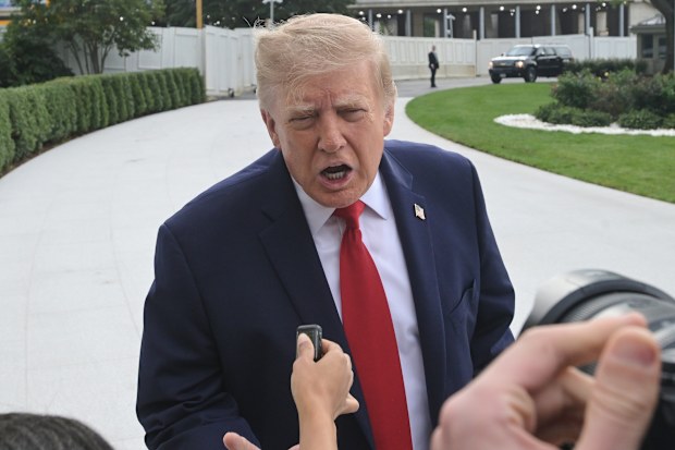 US President Donald Trump talks with reporters on the South Lawn of the White House before boarding Marine One, Saturday, Sept. 26, 2026, in Washington.