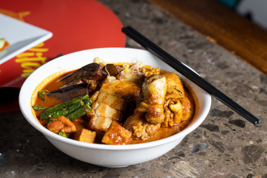 Malaysian curry mee with crispy pork.