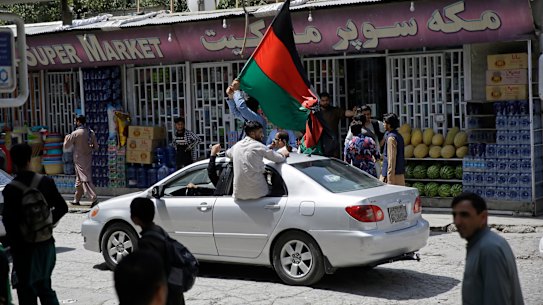Afghans waved national flags in Kabul and several other cities in defiance of the Taliban.