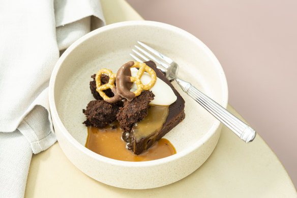 Dark chocolate terrine dessert with sour cream, caramel and salted pretzel.
