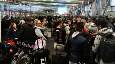 A mass of passengers navigate confusing queues at Sydney Domestic Terminal 2 on Saturday.