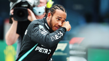 Race winner Lewis Hamilton celebrates winning a seventh F1 championship.
