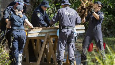 NSW Police search the gardens below a balcony at the home from which William Tyrrell disappeared in Kendall.