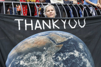 Jemila MacEwan, a supporter of Swedish environmental activist Greta Thunberg, awaits her arrival at a marina in New York.