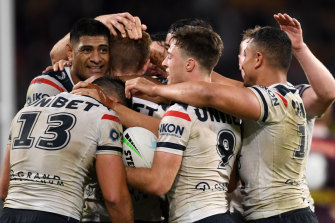 The Roosters celebrate their last-minute win against the Broncos.