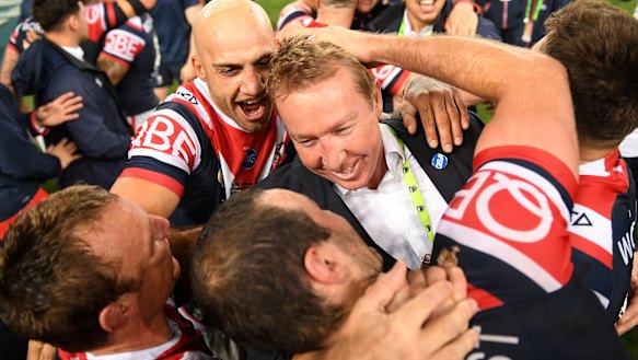 The mastermind: Roosters coach Trent Robinson celebrates with his players.