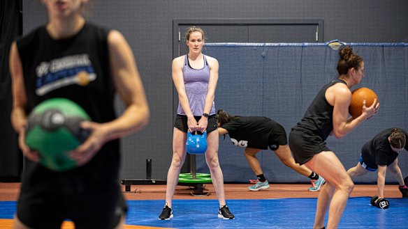 Eyes on the prize: The Canberra Capitals' Marianna Tolo, Keely Froling, Abby Cubillo, Kelsey Griffin, and Kelly Wilson hit the AIS gym.