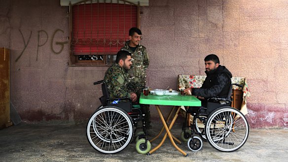 Injured Syrian Democratic Forces soldiers Ibrahim Bazem, 25, left, Sipan Ezzo, 20 (centre) and Swar Rojdam, 23, recuperating from their injuries sustained whilst fighting Islamic State.
