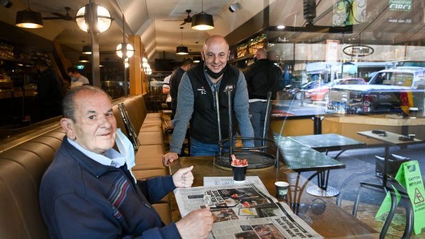 Lygon Street shops and restaurants prepare to open after lockdown.
Cafe Notturno owner Salvatore Cultrera  (standing) with his uncle Bruno Cultrera are opening to dine-in customers from 6am on Wednesday.
