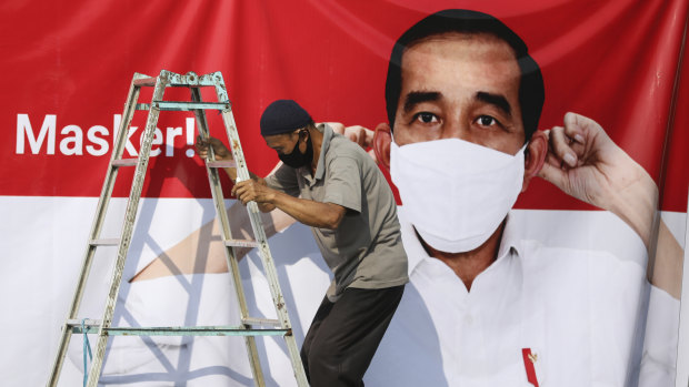 Virus awareness billboards in Jakarta feature President Joko Widodo. 