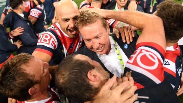 The mastermind: Roosters coach Trent Robinson celebrates with his players.