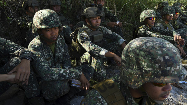 Marines sit on the beach at the Philippine Marine Corp Barracks Gregorio Lim in Ternate, Luzon.