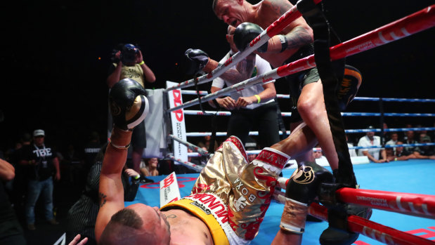 John Wayne Parr punches  Anthony Mundine out of the ring at the Brisbane Exhibition and Convention Centre.