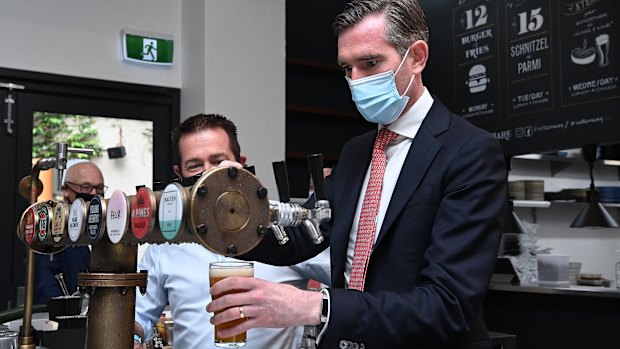 NSW Premier Dominic Perrottet pours a beer at Watson’s pub in Moore Park today.