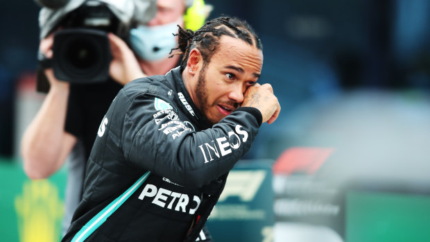 Race winner Lewis Hamilton celebrates winning a seventh F1 championship.