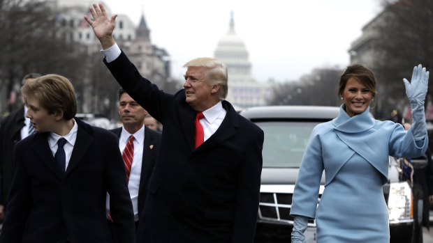 Donald Trump and Melania Trump wave during his inauguration parade on Pennsylvania Avenue, Washington, in 2016.
