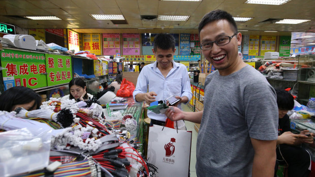 Li Feng buying electronic parts  in Shenzhen’s Huaqiangbei Commercial Street.