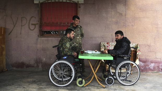 Injured Syrian Democratic Forces soldiers Ibrahim Bazem, 25, left, Sipan Ezzo, 20 (centre) and Swar Rojdam, 23, recuperating from their injuries sustained whilst fighting Islamic State.
