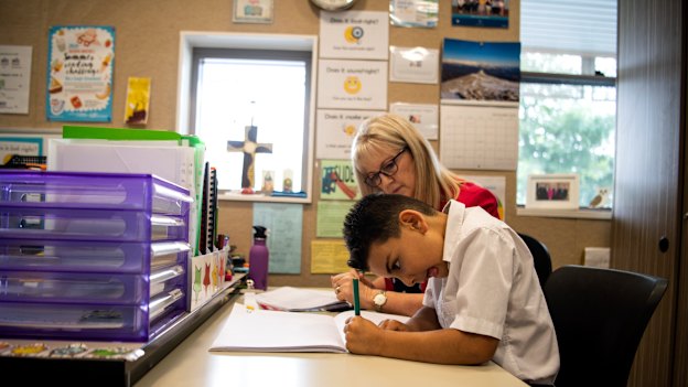 Elias Dahrie, 6, reads using a whole-language method with teacher Maree Grainger.
