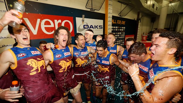 Hodge, third from the left, celebrates with teammates during a round nine match against the Hawks in 2018.  
