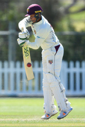 Caught on the hop: Usman Kjawaja on the defensive against the Tasmanian attack.