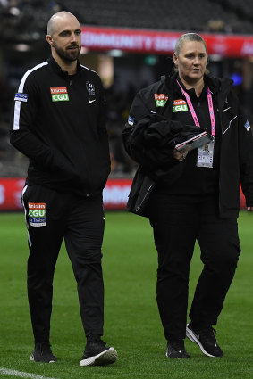 Steele Sidebottom (left) walks around the boundary line on Friday night. 