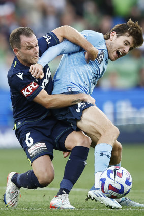 Victory’s Leigh Broxham wrestles Sydney FC goal-scorer Max Burgess. 