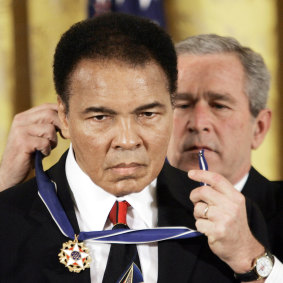 The US president George W Bush presents the Presidential Medal of Freedom to boxer Muhammad Ali in 2009.