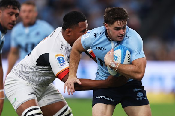 Teddy Wilson of the Waratahs is tackled.