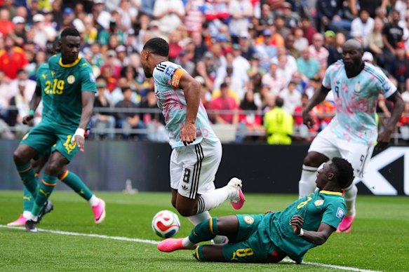 Senegal's Lamine Camara tackles Belgian Youri Tielemans with a penalty kick.