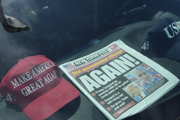 A newspaper is displayed in a vehicle outside of Mar-a-Lago after the apparent assassination attempt of Republican presidential nominee and former President Donald Trump Monday.