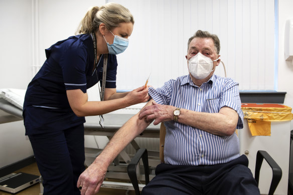 A nurse administers the AstraZeneca vaccine to a man in Dundee, Scotland, on January 4.