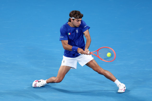 Flavio Cobolli hits a backhand against Dominic Stricker of Switzerland.