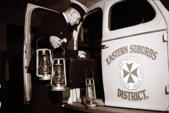 "Driver N. Hanson, who drives the all-night emergency 'maternity truck' of Eastern Suburbs Ambulance, was ready with storm-lanterns in case of a sudden call." October 14, 1945