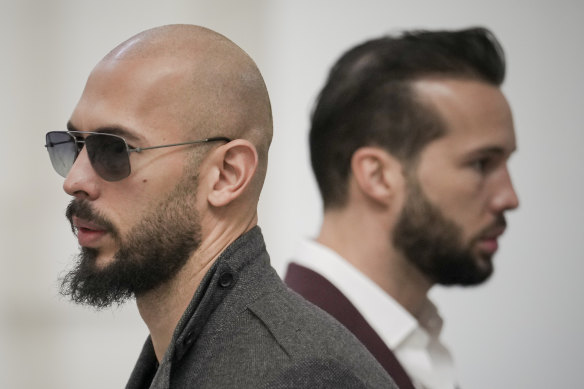 Andrew Tate, left, and his brother Tristan wait inside the Court of Appeals building in Bucharest, Romania, in January.