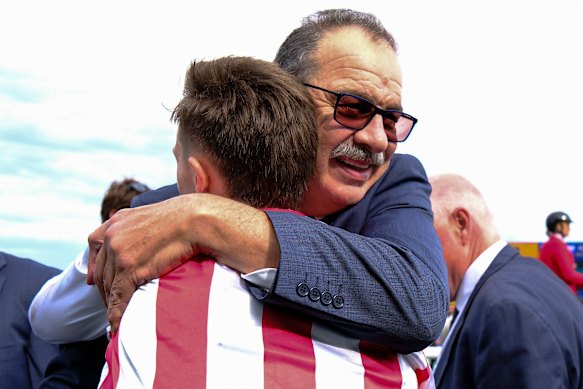 Trainer John Sargent embraces Dylan Gibbons.
