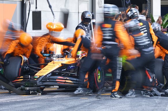 Oscar Piastri visits the McLaren pits.