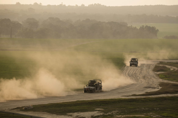 Israeli military vehicles move back from the Gaza Strip in Israel.