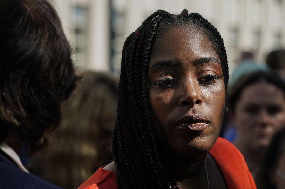 Jovante Cunningham, who says Kelly abused her, pauses to consider her view of his 30-year sentence while speaking to the media outside court.