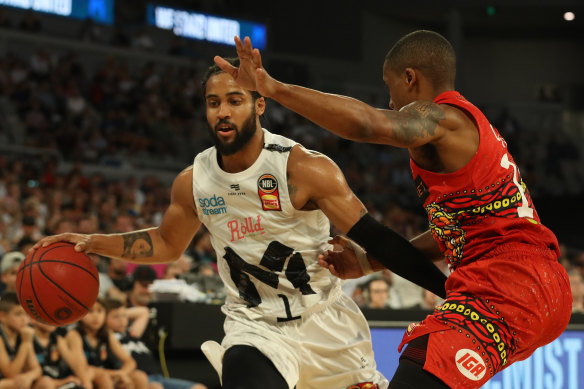 Melo Trimble brushes off Bryce Cotton during Melbourne United's victory over the Perth Wildcats on Wednesday.