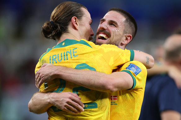 Jackson Irvine and Milos Degenek celebrate the win.