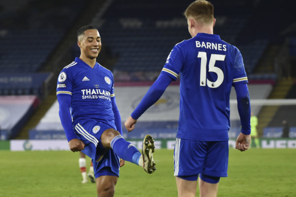 Harvey Barnes (right) celebrates with Youri Tielemans - from a distance - after scoring Leicester's second goal.
