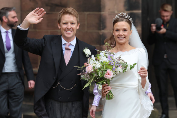 Hugh Grosvenor, Duke of Westminster and Olivia Grosvenor, Duchess of Westminster wave and smile to well-wishers after their wedding ceremony.