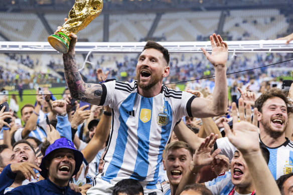 Argentina’s Lionel Messi celebrates with the World Cup trophy. 