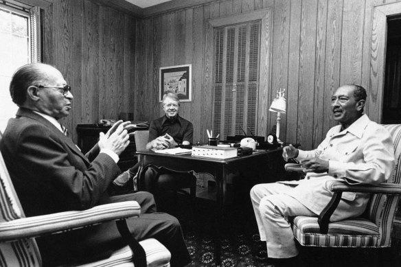 Israeli Prime Minister Menachem Begin, left, President Jimmy Carter, center, and Egyptian President Anwar Sadat begin their second day of peace talks at Camp David, Maryland.