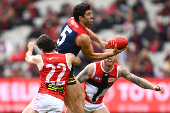 Christian Petracca gets a handball away under pressure.